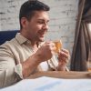 Businessman in quarantine drinking an immune-boosting beverage