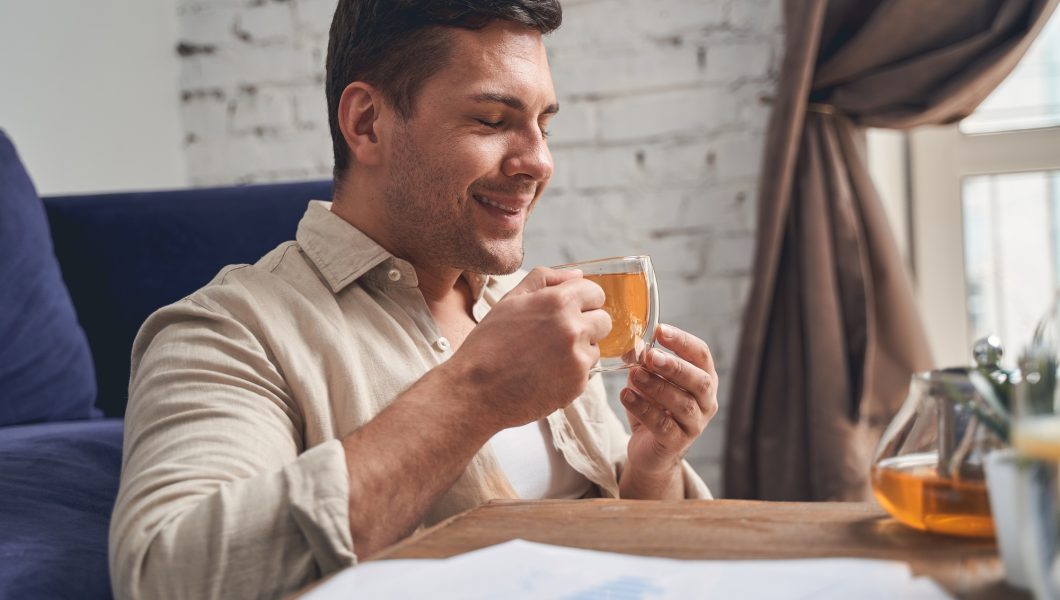 Businessman in quarantine drinking an immune-boosting beverage