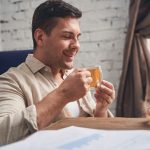 Businessman in quarantine drinking an immune-boosting beverage