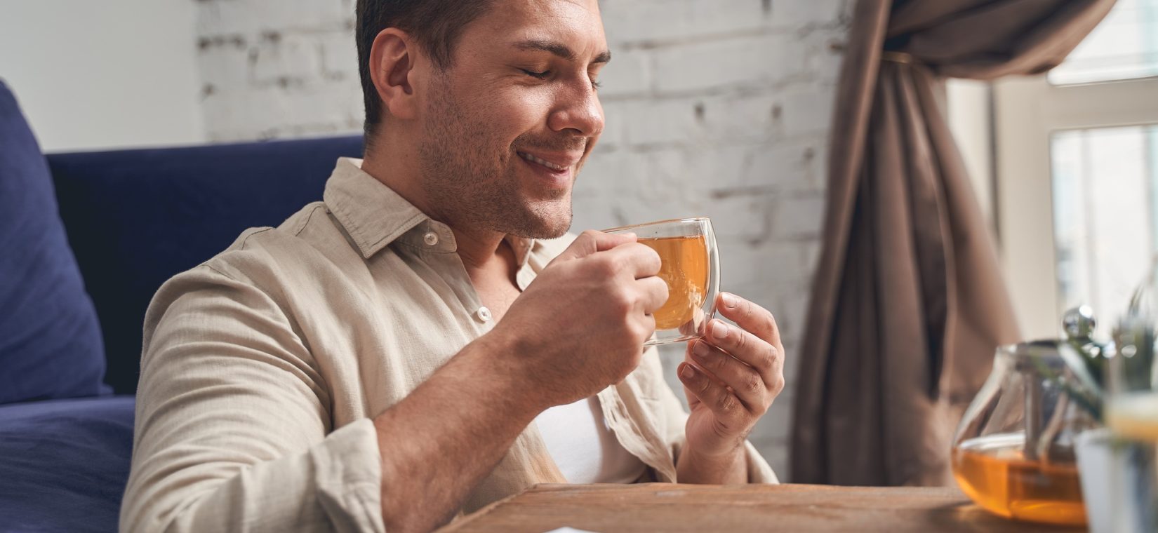 Businessman in quarantine drinking an immune-boosting beverage